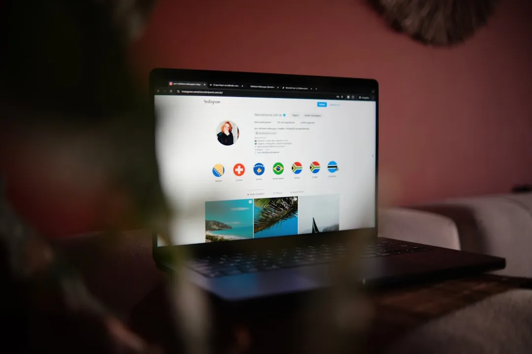 A laptop computer sitting on top of a wooden table